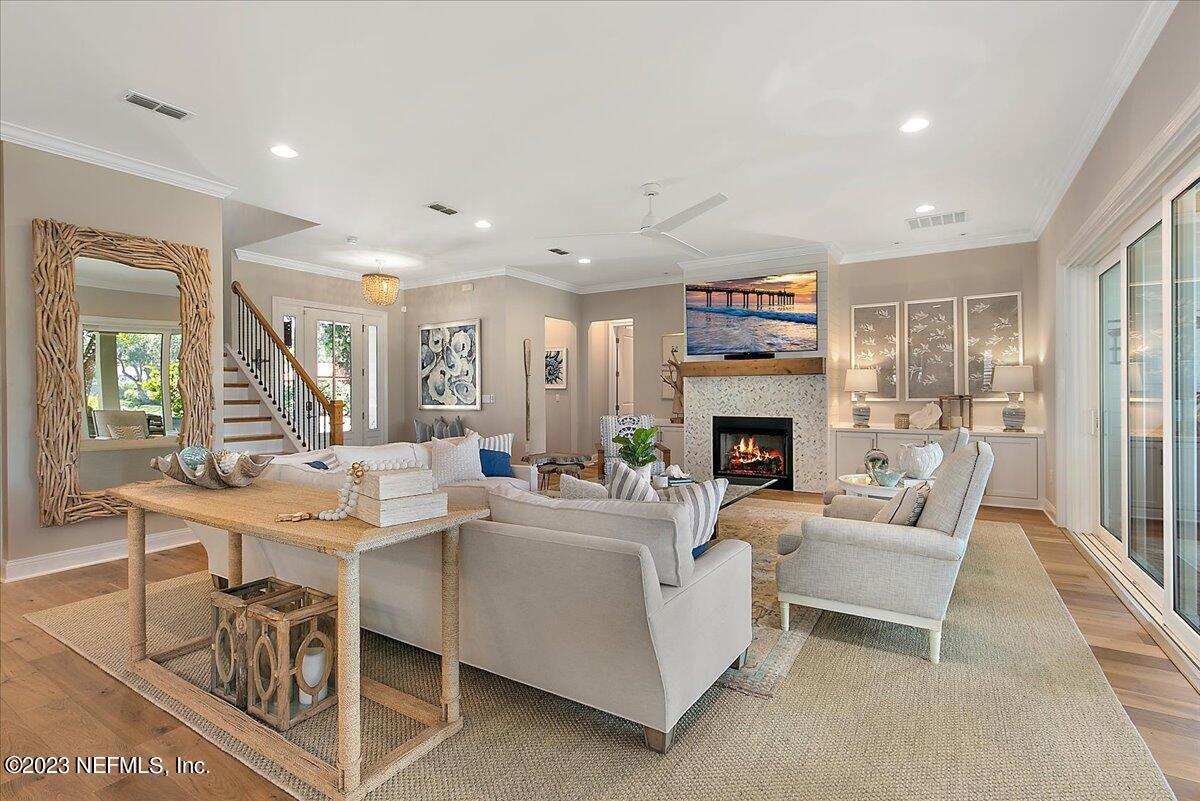 A living room with couches, chairs and a fireplace.